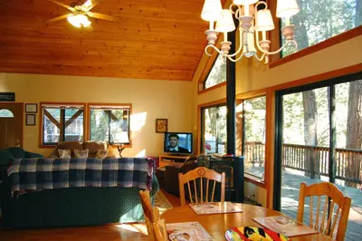 a living room with a couch and a table and chairs at 5N Edmond's Place in Wawona