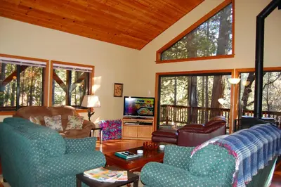 a living room with two couches and a tv at 5N Edmond's Place in Wawona