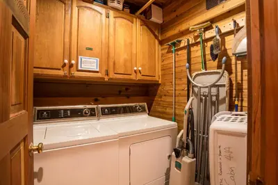 a laundry room with a washer and a refrigerator at 41A Cedar Chalet in Wawona