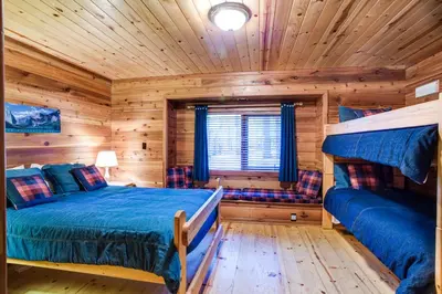 a log cabin bedroom with a bed and a couch at 41A Cedar Chalet in Wawona