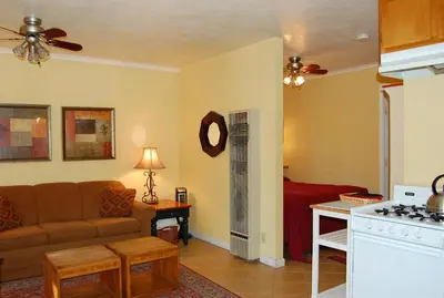 a living room with a couch and a bed at 65 Sparrows Nest in Wawona
