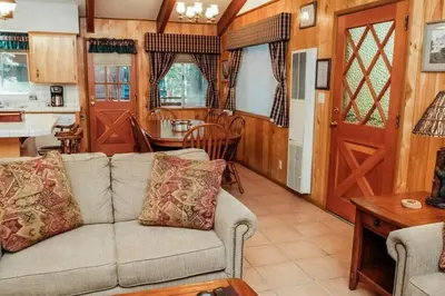 a living room with a couch and a table at 19B Yosemite Retreat in the Meadows in Wawona