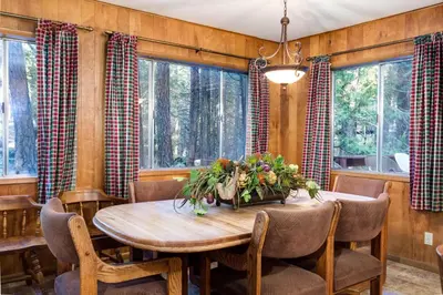 a dining room with a wooden table and chairs at 4 Pine Creek Cabin in North Wawona