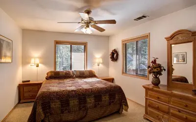 a bedroom with a bed and a ceiling fan at 12 Cabin Twelve in Wawona