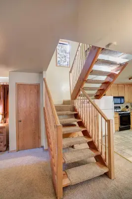 a wooden staircase in a room with a kitchen at 12 Cabin Twelve in Wawona