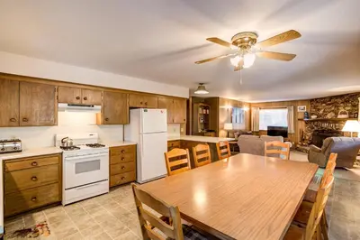 a kitchen with a wooden table and a ceiling fan at 9B Deer Hollow in Wawona