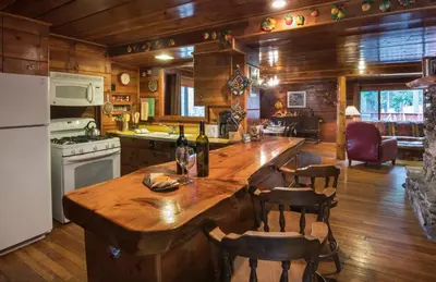 a kitchen with a large wooden island in a cabin at 37 Wapiti in North Wawona