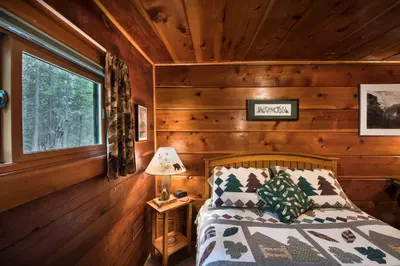 a bedroom with a bed in a log cabin at 37 Wapiti in North Wawona