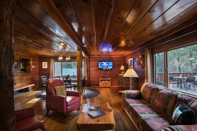 a living room with a couch and a table at 37 Wapiti in North Wawona