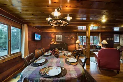 a dining room with a table and chairs and a room at 37 Wapiti in North Wawona