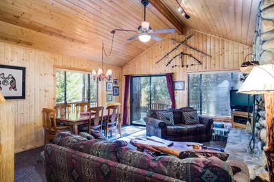 a living room with a couch and a table at 21 River Refuge in North Wawona