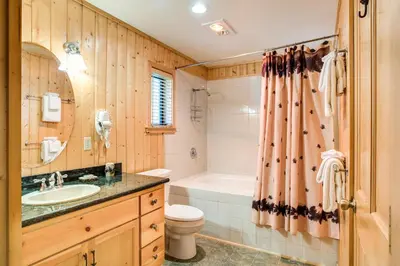 a bathroom with a sink and a toilet and a tub at 21 River Refuge in North Wawona