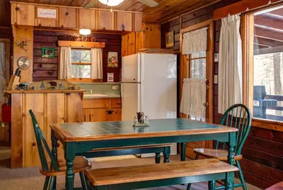 a kitchen with a table and a refrigerator at 51 Mia Mora in Wawona