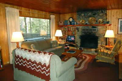 a living room with a couch and a fireplace at 11 Shangri la-de-da in Wawona