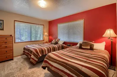 two beds in a room with red walls at 69 Bordentown West in Wawona