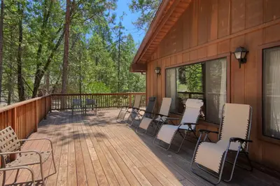 a deck with chairs and tables on a house at 69 Bordentown West in Wawona