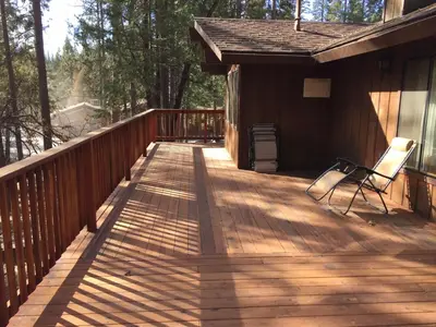 a wooden deck with a chair on it at 69 Bordentown West in Wawona