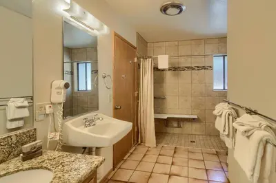 a white bathroom with a sink and a shower at 69 Bordentown West in Wawona
