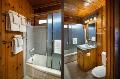a bathroom with a tub and a toilet and a sink at 72 Sequoia in North Wawona