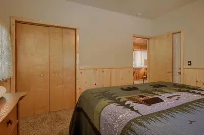a bedroom with a bed and a dresser in it at 43R Edna's Hearts Desire in North Wawona