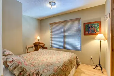 a bedroom with a bed and a window at 7S Wawona Chalet in Wawona