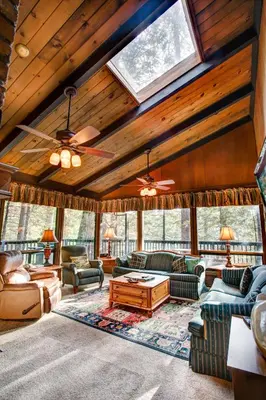 a living room with couches and a ceiling with windows at 18B Hiltbrand Hangout in Wawona