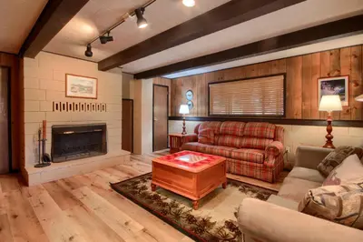 a living room with a couch and a fireplace at 18B Hiltbrand Hangout in Wawona