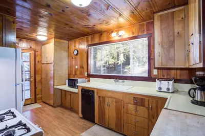 a kitchen with wooden cabinets and a sink and a window at 50R Soots-Me in Wawona