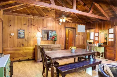a dining room with a wooden table and chairs at 50R Soots-Me in Wawona