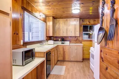 a kitchen with wooden cabinets and a microwave at 50R Soots-Me in Wawona