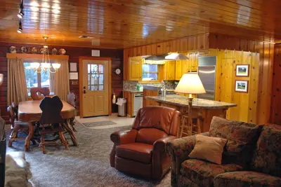 a living room with a couch and a table and a kitchen at 79 Half Dome in Wawona