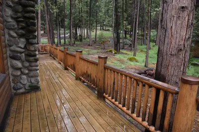 a wooden deck in the middle of a forest at 79 Half Dome in Wawona