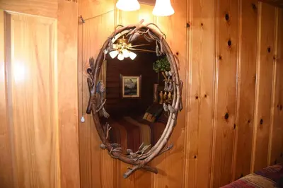 a mirror on a wall with a bed in a room at 79 Half Dome in Wawona