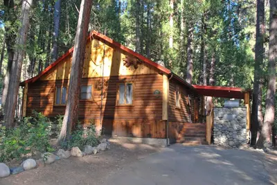 a wooden cabin in the middle of a forest at 79 Half Dome in Wawona