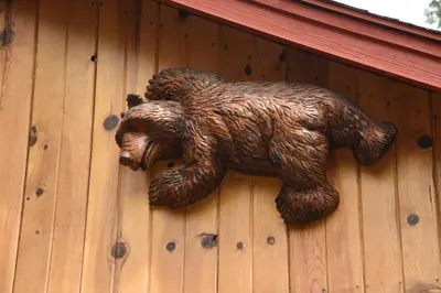 a statue of a bear on the side of a building at 79 Half Dome in Wawona
