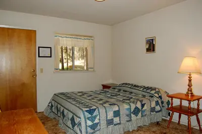 a bedroom with a bed and a table and a window at 47R Altitude Adjustment in North Wawona