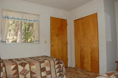 a bedroom with a bed and a window and a door at 47R Altitude Adjustment in North Wawona