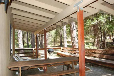a porch with a picnic table and a grill at 47R Altitude Adjustment in North Wawona