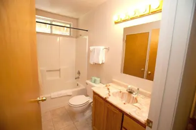 a bathroom with a sink and a toilet and a mirror at 47R Altitude Adjustment in North Wawona