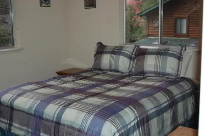 a bed in a room with a window at 47R Altitude Adjustment in North Wawona