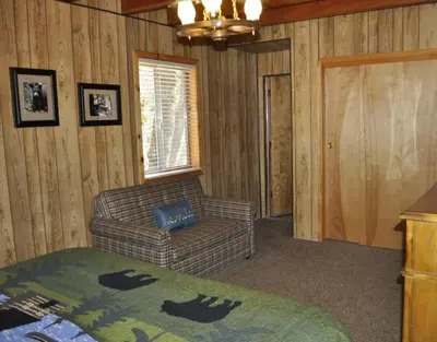 a living room with a couch and a chair at 44R Grant's Camp in Wawona