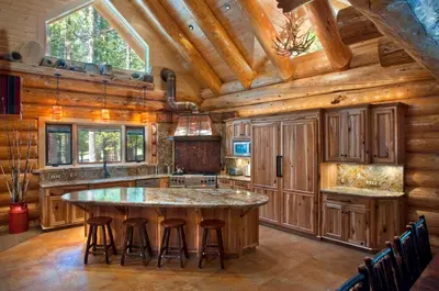 a kitchen with a large island with bar stools at 67 El Capitan in North Wawona