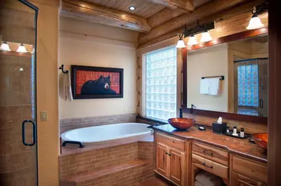 a bathroom with a tub and a large mirror at 67 El Capitan in North Wawona