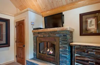 a fireplace with a television on top of it at 67 El Capitan in North Wawona