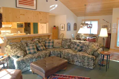 a living room with a couch and a table at 93 Doyles Mountain in Wawona