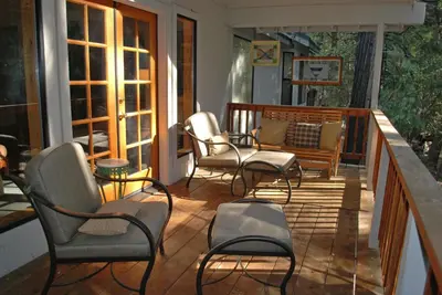 a porch with chairs and a bench on it at 93 Doyles Mountain in Wawona