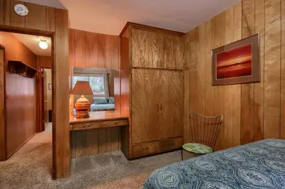 a bedroom with a bed and a desk with a lamp at 25A Villarreal Retreat in Wawona