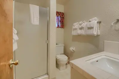a white bathroom with a toilet and a sink at 25A Villarreal Retreat in Wawona