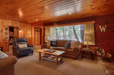 a living room with a couch and a table at 57 The Williams Cabin in Wawona