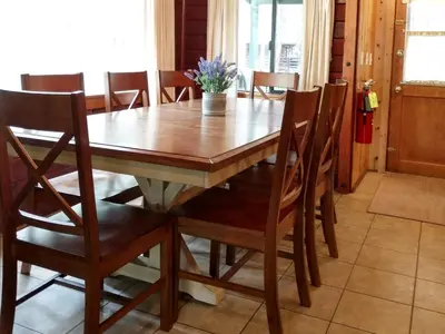 a dining room table with chairs and a wooden table at 57 The Williams Cabin in Wawona
